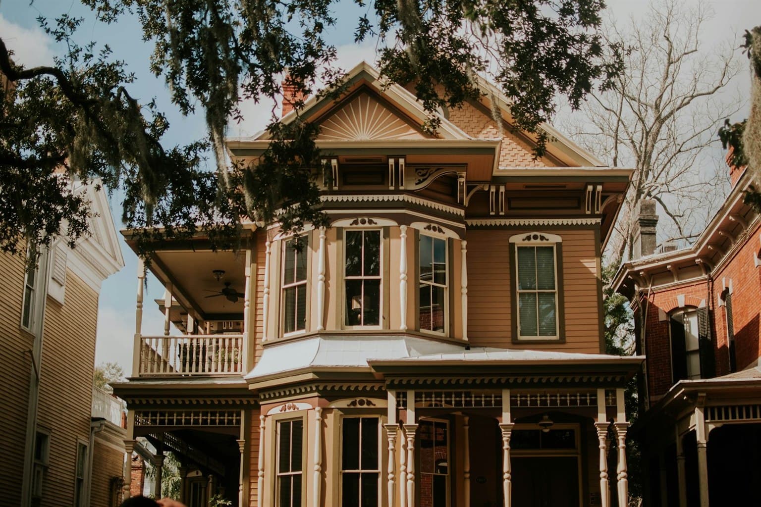 Victorian home with faded, dated paint and bare landscaping before improvements