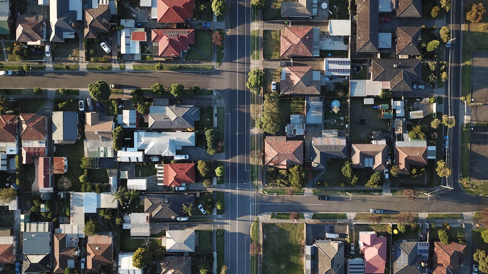 Aerial view of a leafy suburban neighborhood like those we serve across Suffolk County